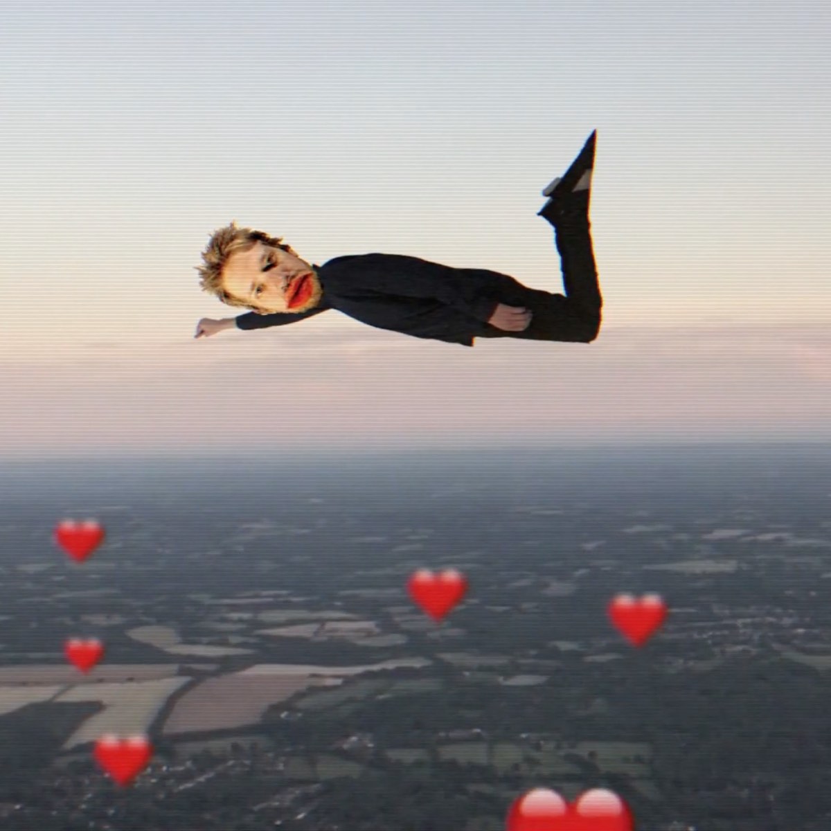 spencer avatar flying over fields with heart emojis